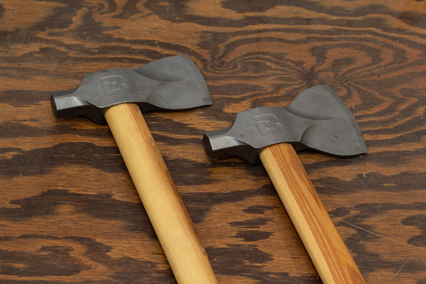 Two Bauer hatches laying on rustic wood surface made by Boss Hammer Co