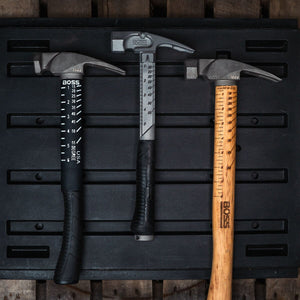 Titanium Framing Hammers with built-in squaring system for straight lines and marking angles on the go. This hammer is in a construction site leaning against a wall