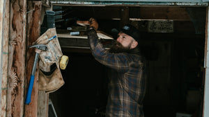 Woodworker using boss hammer steel framing hammer in a shed
